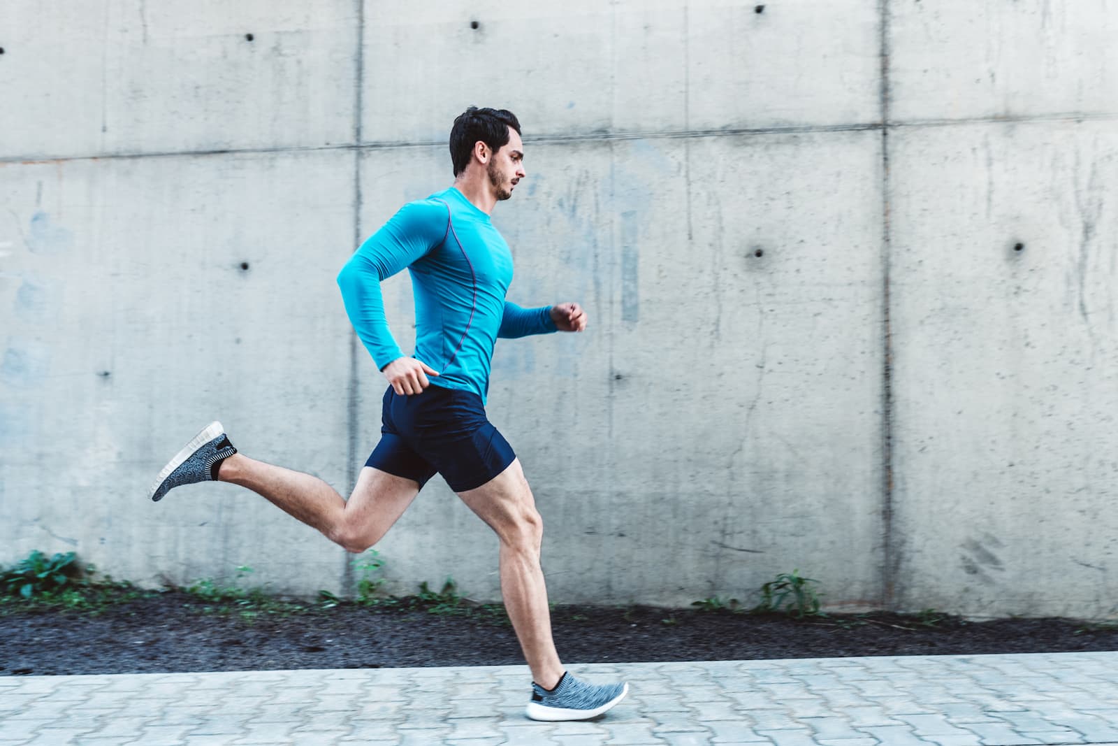 man running down the street in athletic clothes